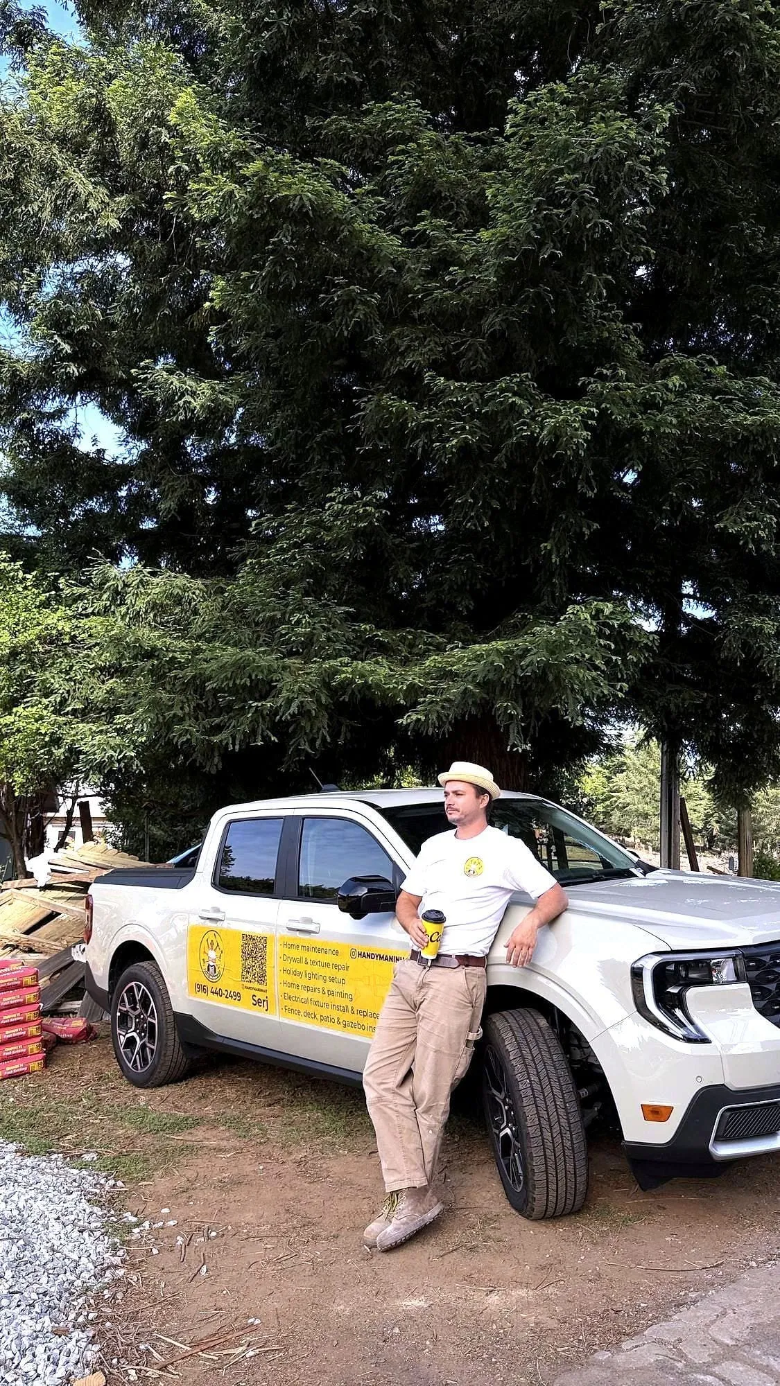 Serj beside his branded truck, where the tools live