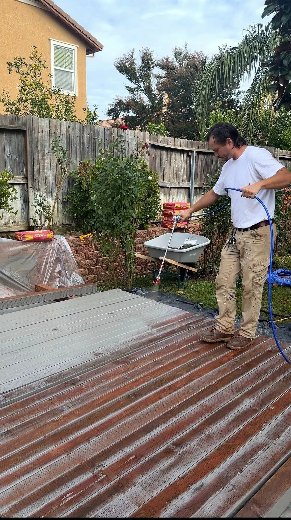 A deck stripped back to the frame on a Sacramento job, boards lifted for inspection